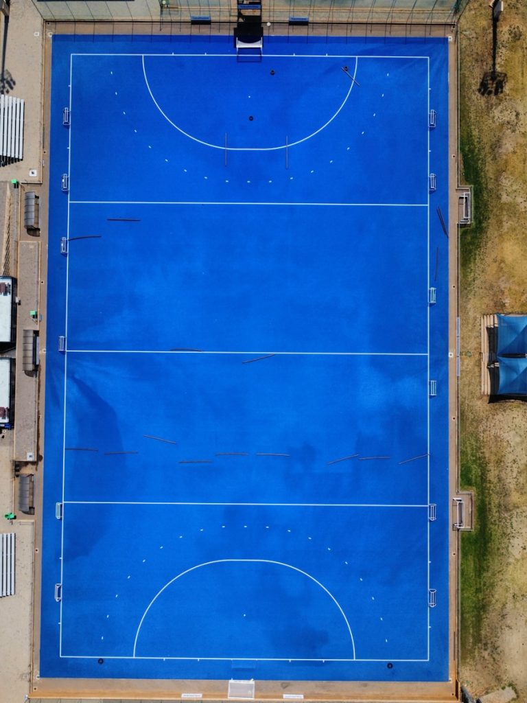 an overhead view of a blue basketball court